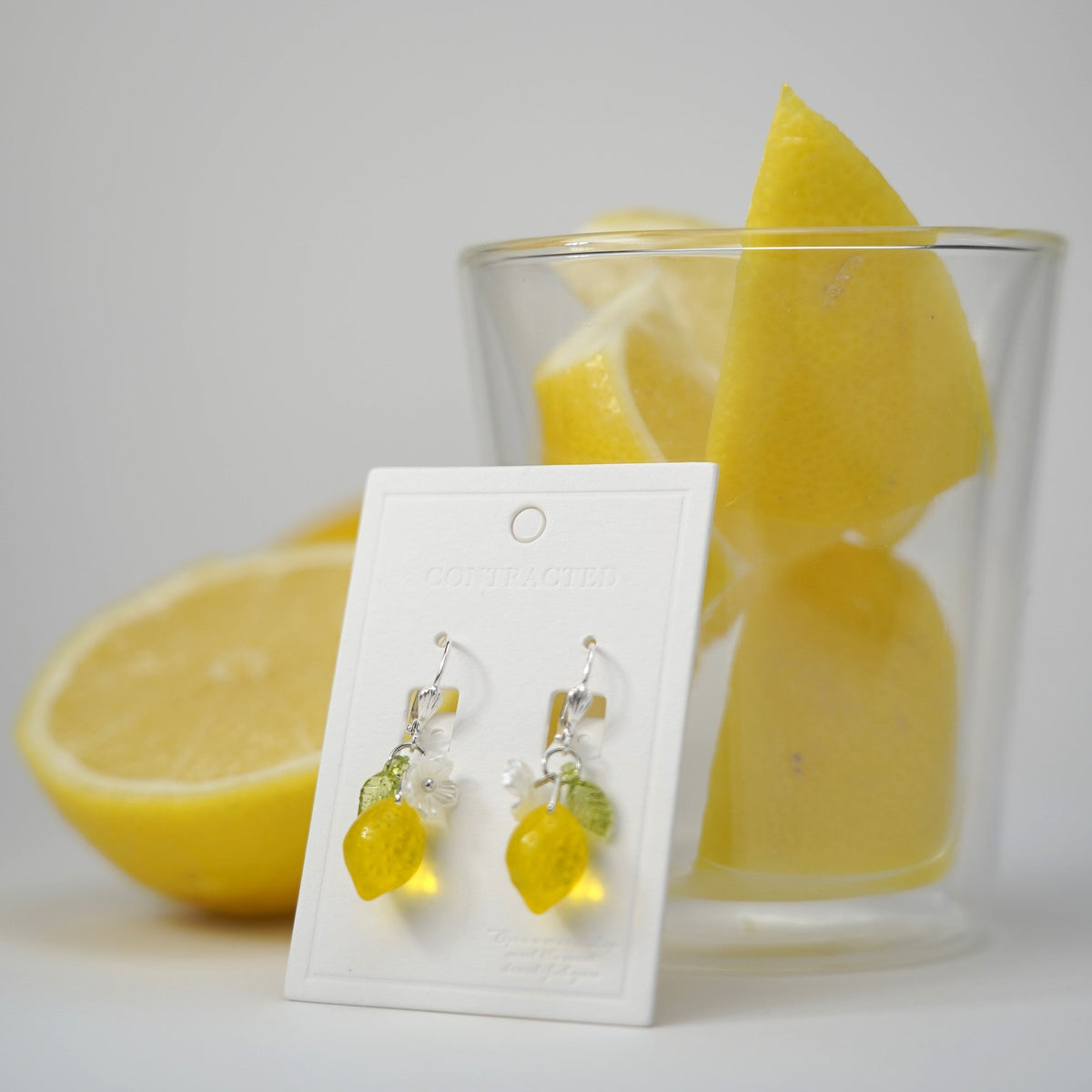 Handmade lemon fruit dangle earrings with silver hook settings, dangling yellow lemon drops.