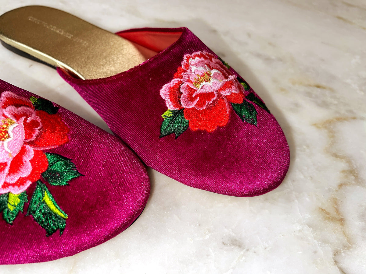 Fuchsia velvet mules with peony embroidery, angled side-by-side view