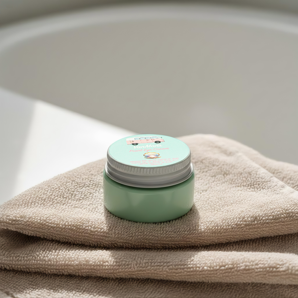 VanMan's Pearl eye cream jar on folded beige towel, mint-green container