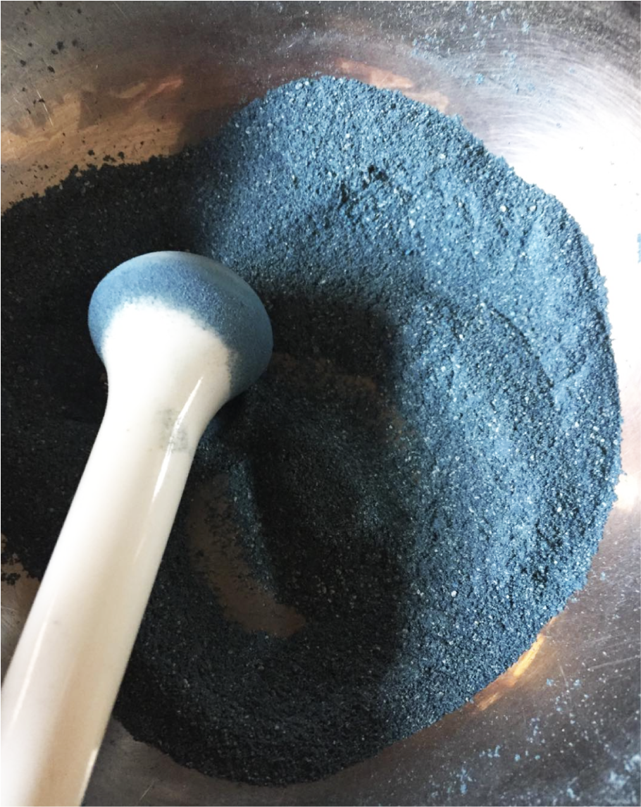 Large round indigo pigment wheel in a workshop, no pillow visible