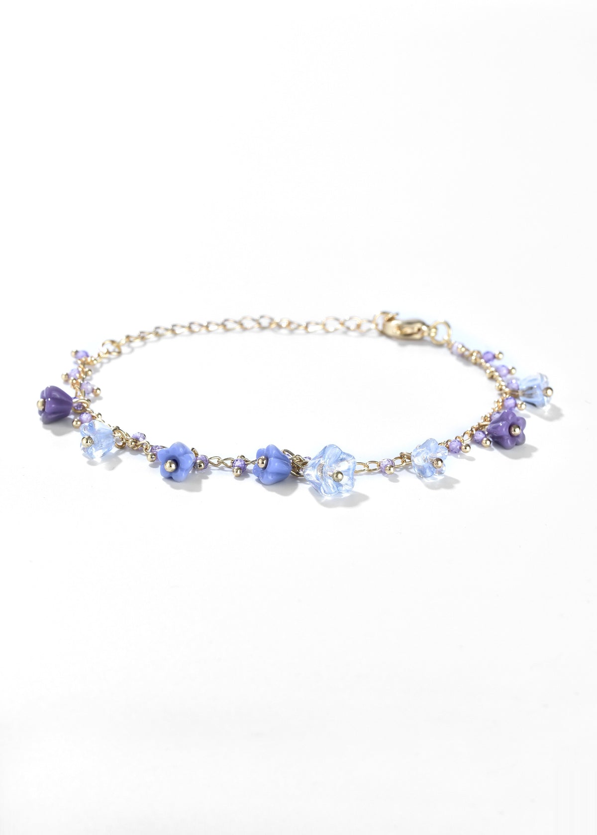 Purple flower charm bracelet with blue beads and gold-tone chain