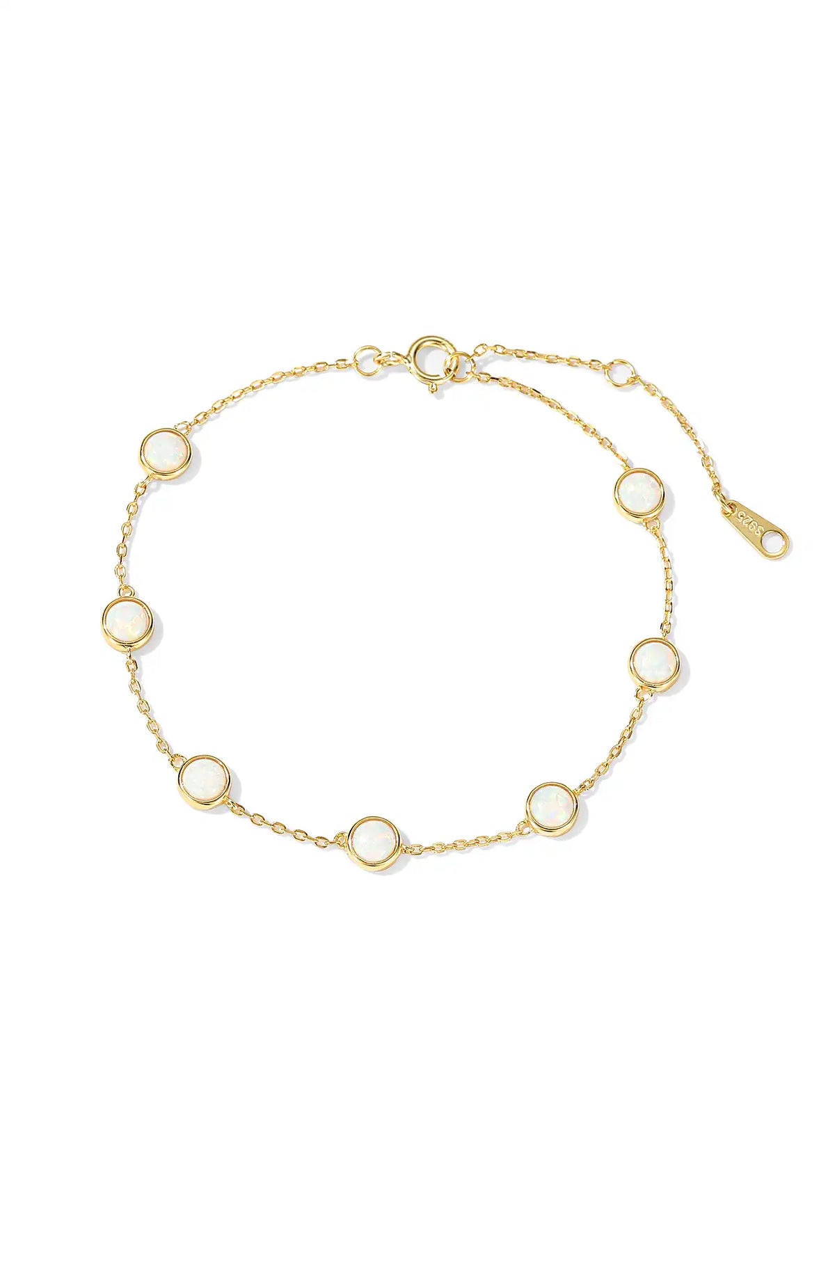 Gold charm bracelet with a fine chain and round bezel-set charms