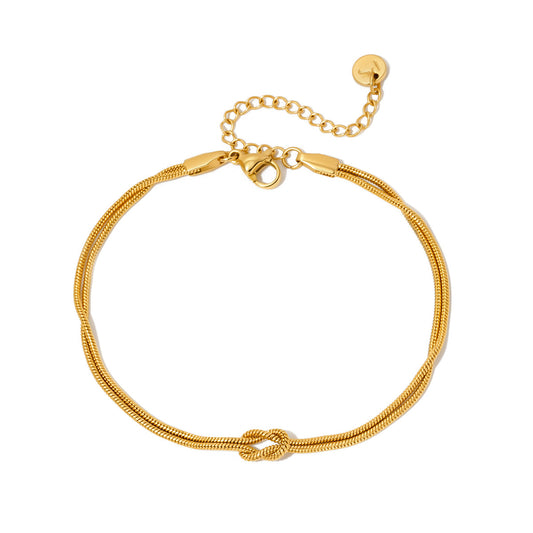 Gold-tone tie-knot cord bracelet with lobster clasp and chain extender