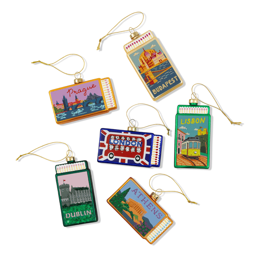 Assorted city matchbook ornaments with hanging cords and metal tops, multiple designs