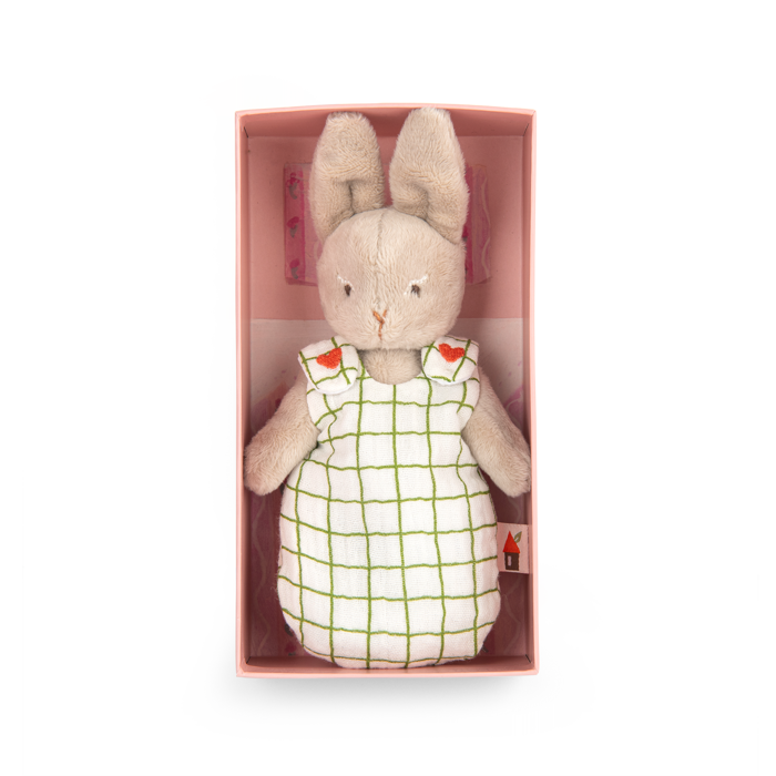 Plush rabbit doll in a white grid-pattern dress, shown inside its pink box
