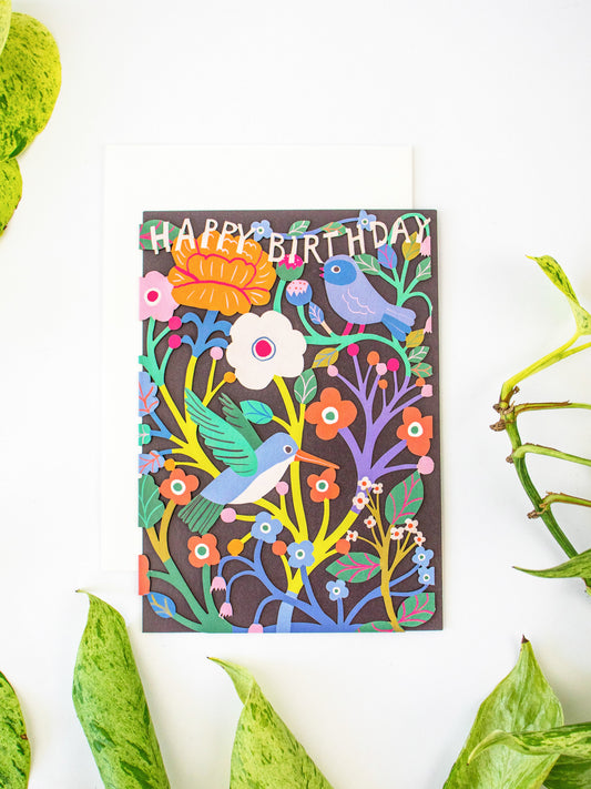Upright laser-cut birthday card featuring colorful birds, flowers, and “Happy Birthday”