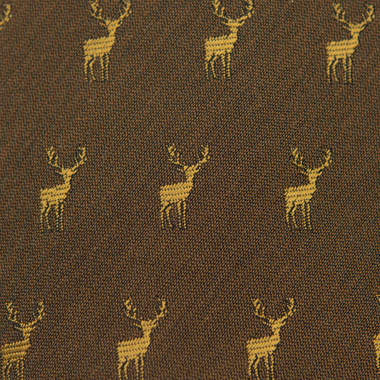 Fabric close-up with repeating yellow deer icons on dark brown