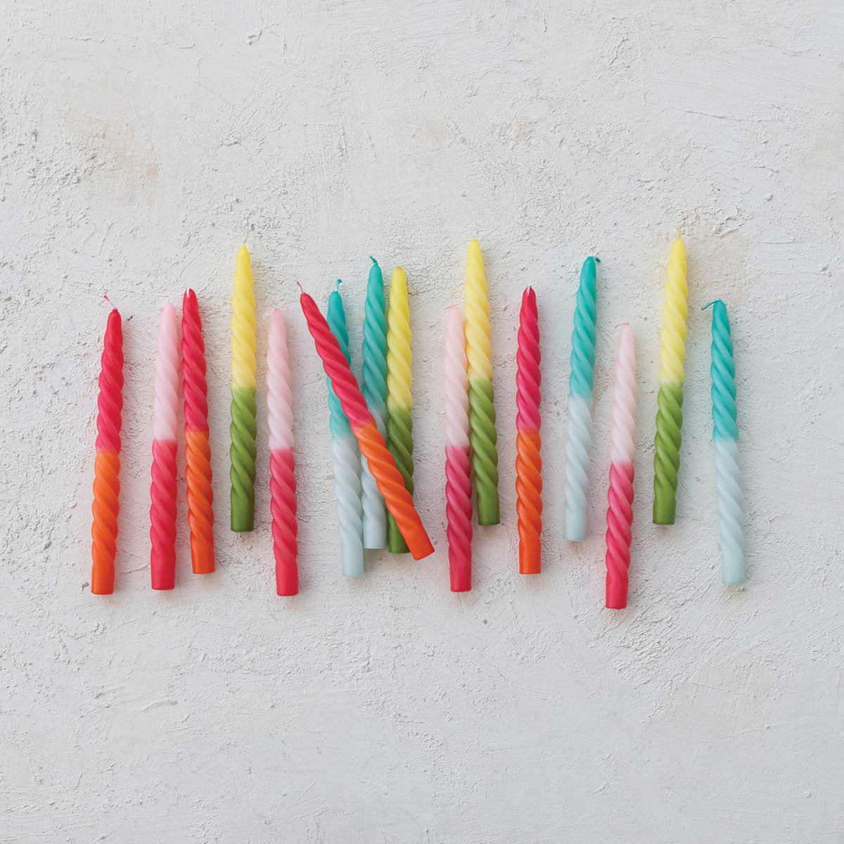 Twisted taper candles array with multicolor ombre twists and tapered wicks