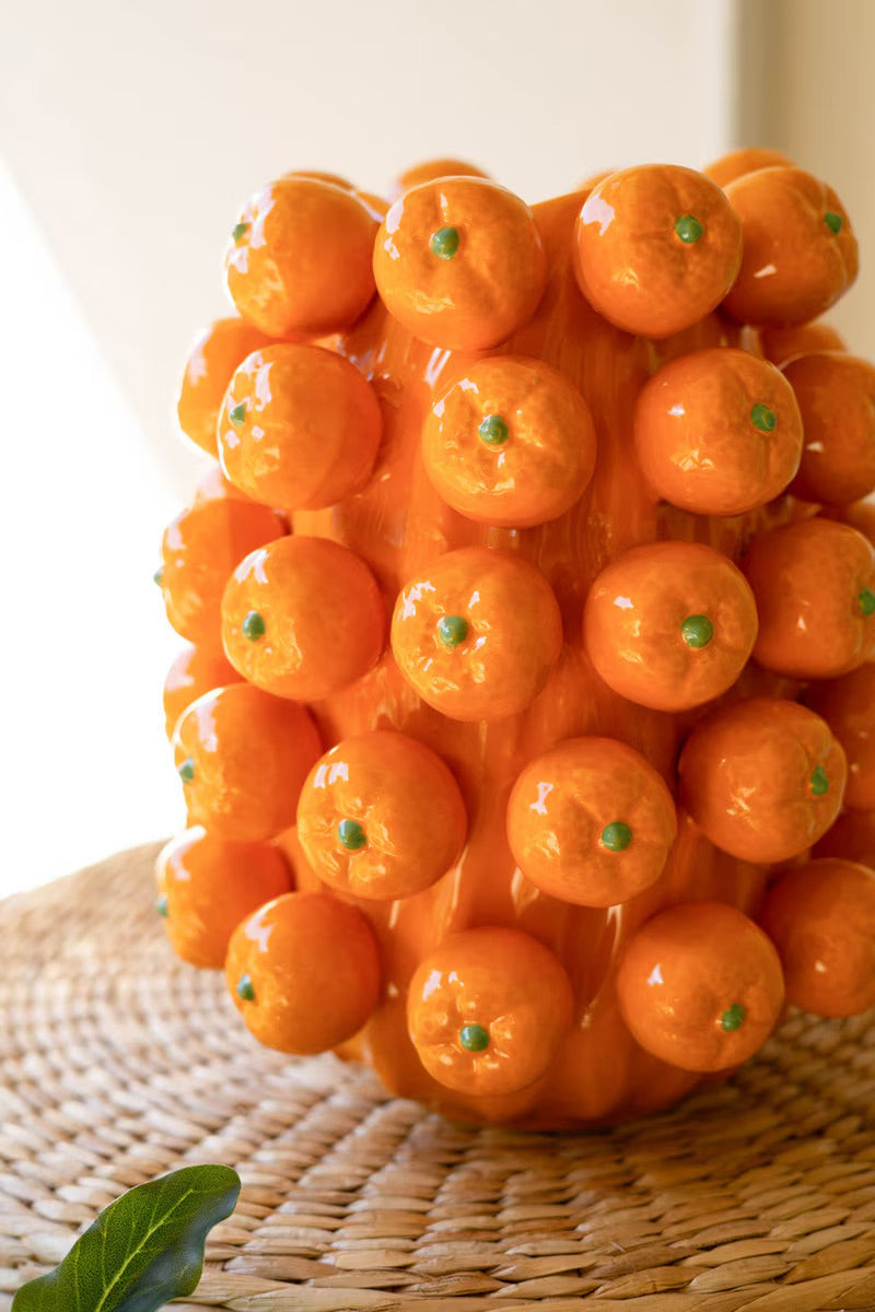 Orange ceramic cluster vase front view of glossy sphere cluster with green dot details
