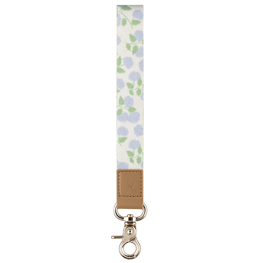 Leaf-pattern wrist lanyard with tan leather patch and metal key ring clasp