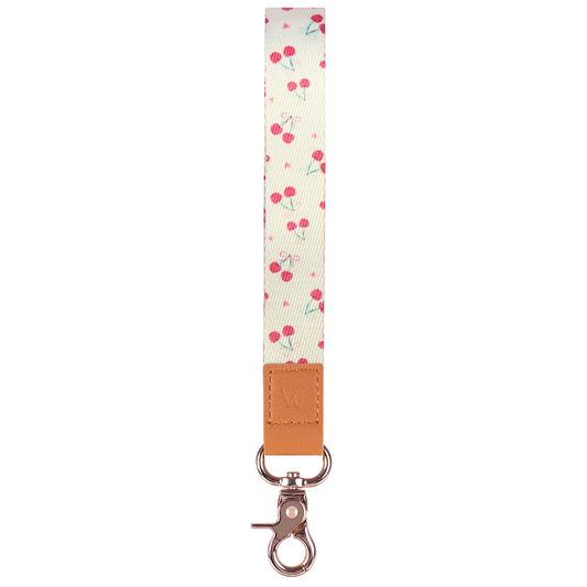 Cherry print wrist lanyard with tan leather tab and gold key clasp