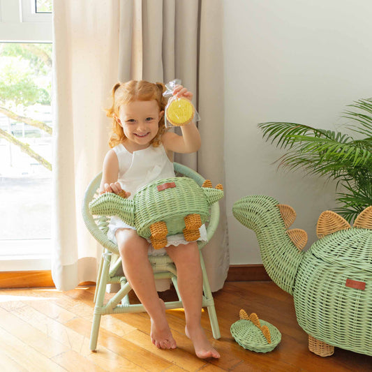 Small mint green dinosaur-shaped rattan basket with a woven tail, spikes, and feet.