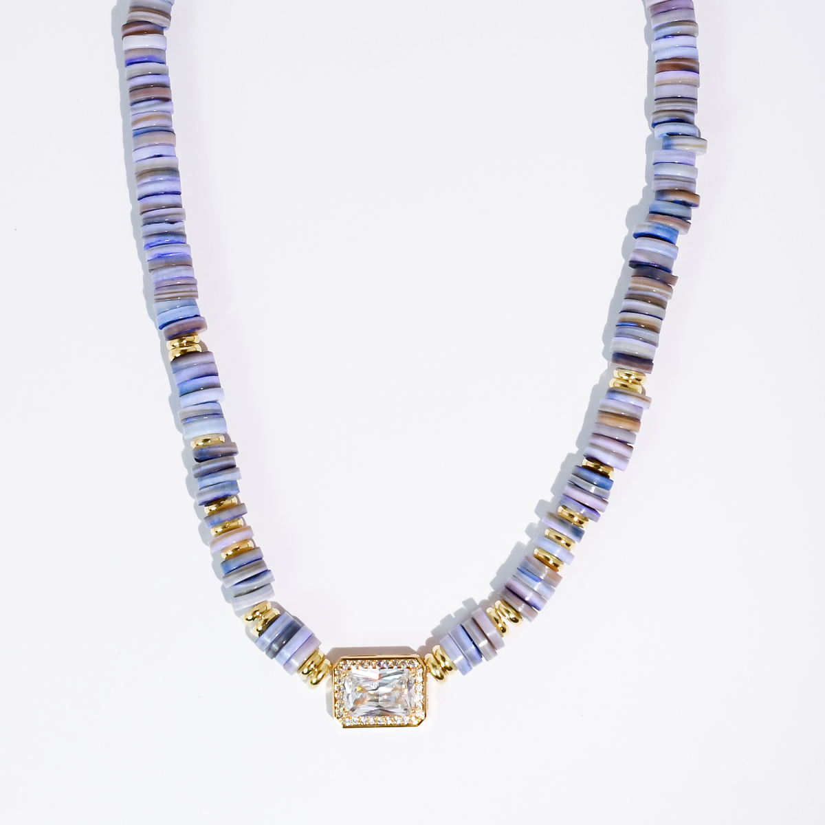 Blue heishi beaded necklace with gold-toned square gem pendant and striped ribbed beads.