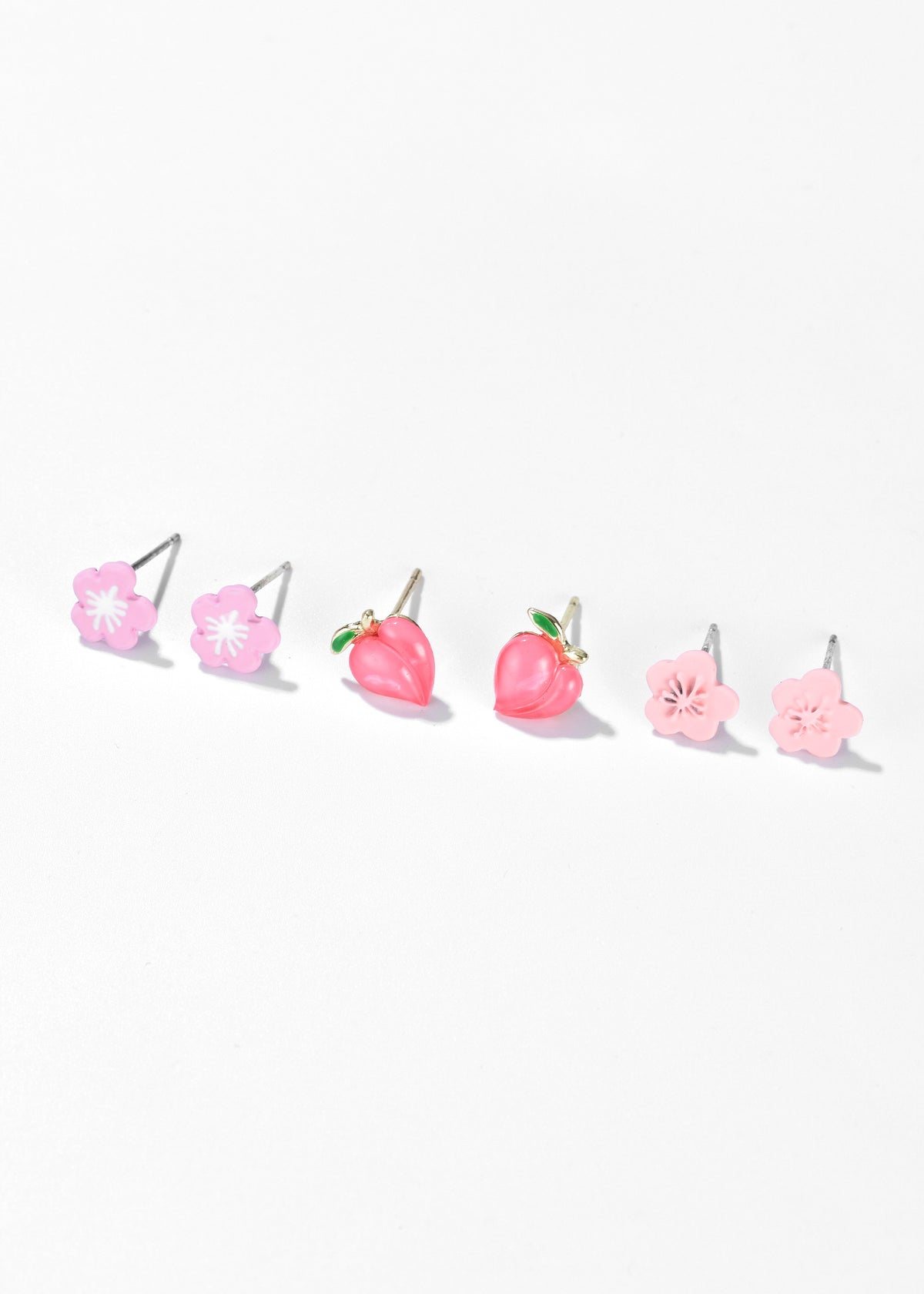 Three pairs of pink stud earrings: two flower designs and one strawberry design