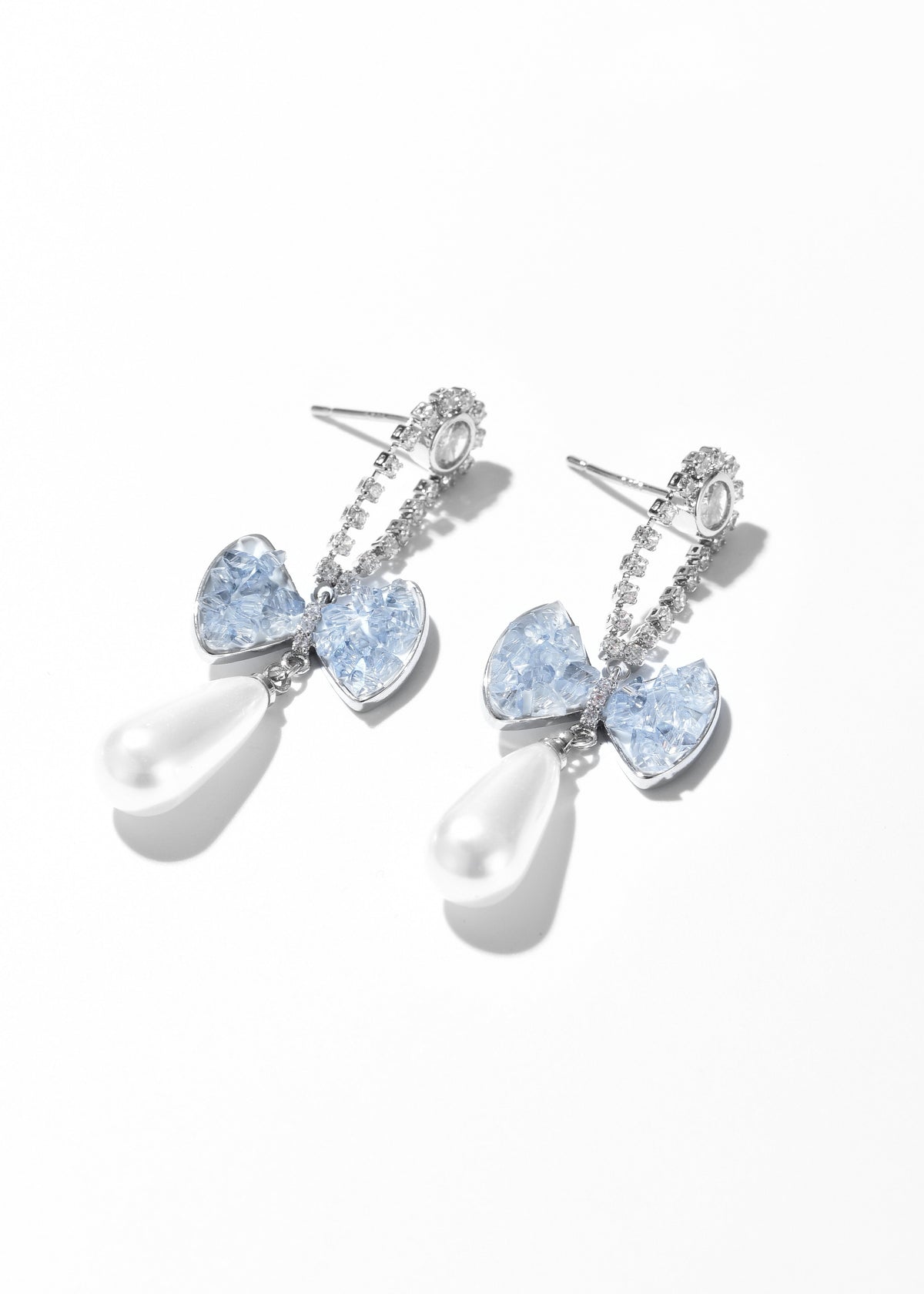 Pair of teardrop pearl earrings with pale blue heart-shaped stones and silver-tone details