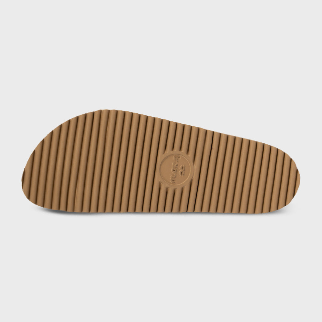 Tan ribbed outsole of speckled slide sandals with embossed logo near toe.