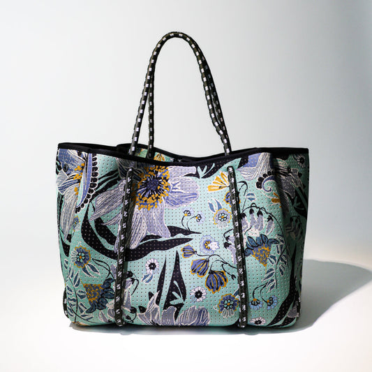 Mint floral tote bag with black trim, zip-top, and striped handles