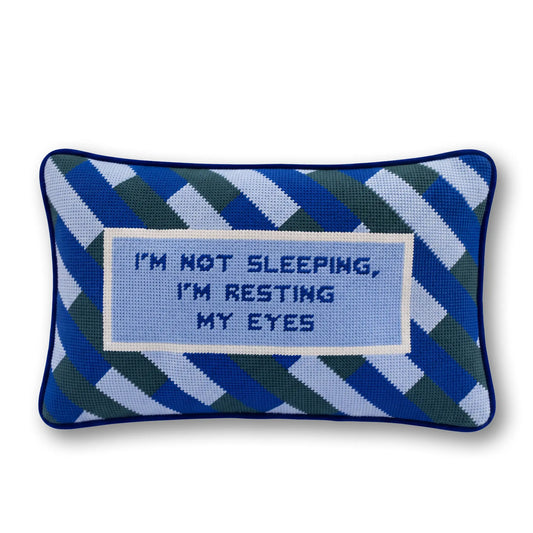 Needlepoint resting eyes pillow with blue geometric pattern and stitched message