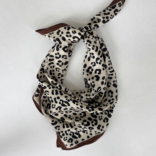 Leopard print square scarf, looped and knotted with brown and cream tones