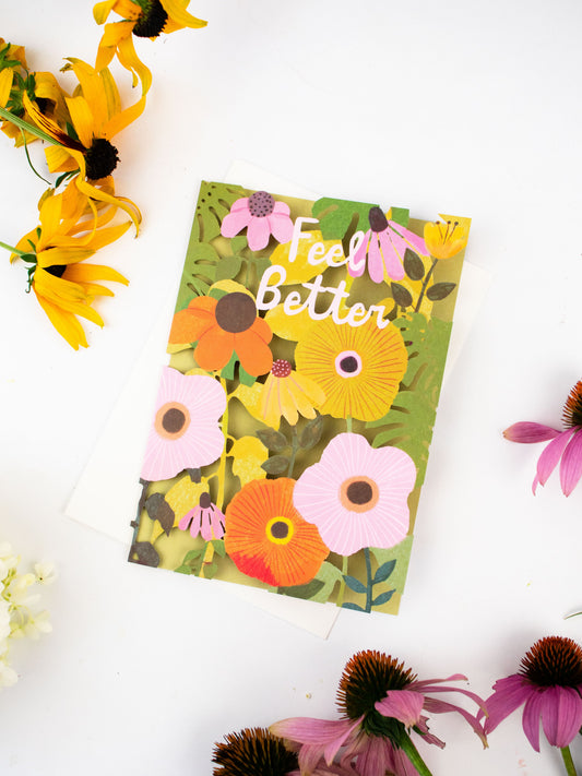 Floral laser-cut greeting card with “Feel Better” text and colorful flower cutouts