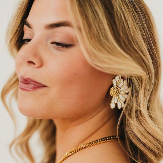 Gold flower stud earrings with white petals and textured center