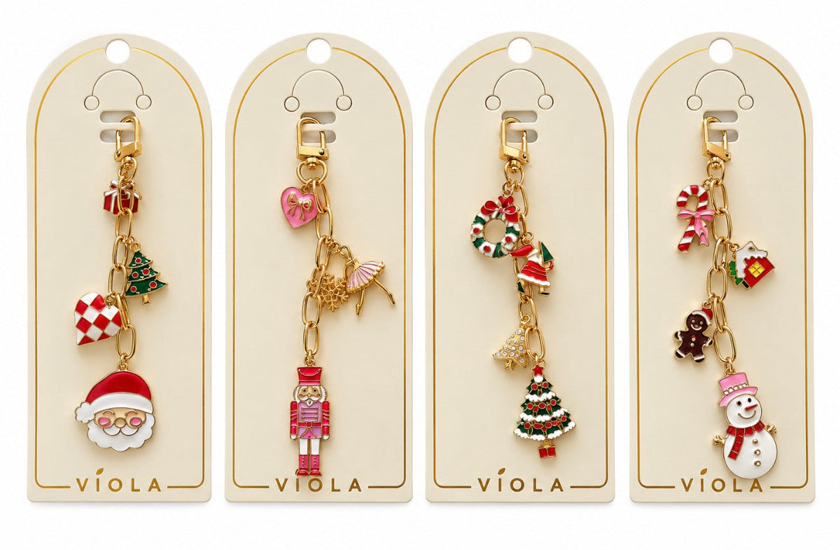 Set of four holiday bag charms with Santa, nutcracker, Christmas tree, and snowman designs