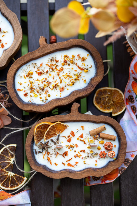 Wooden pumpkin dough bowl candle with cinnamon sticks and orange spice confetti in wax