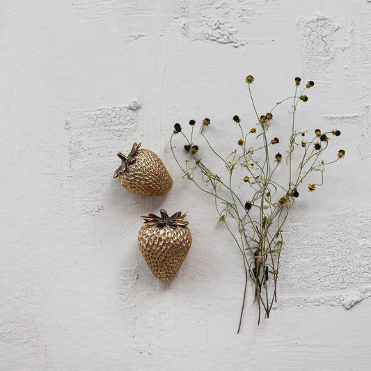 Set of two gold resin strawberries with leafy tops, small decorative fruit accents