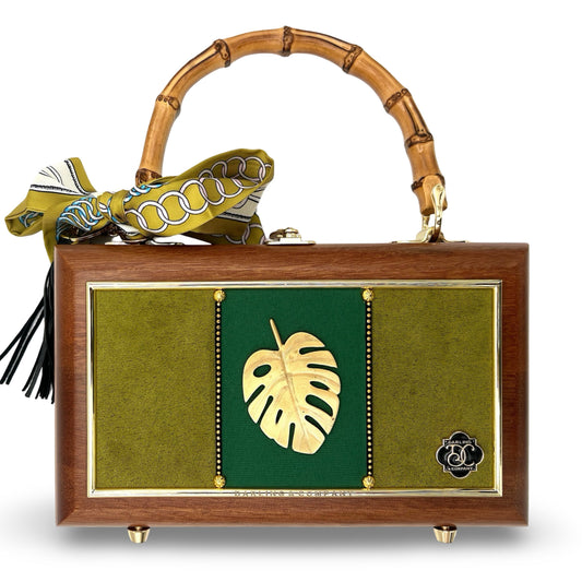 Wooden bamboo-handle handbag with green field and centered gold leaf emblem
