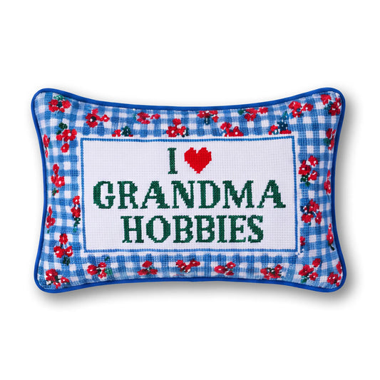 Needlepoint throw pillow with blue gingham floral border and “I ♥ Grandma Hobbies” text