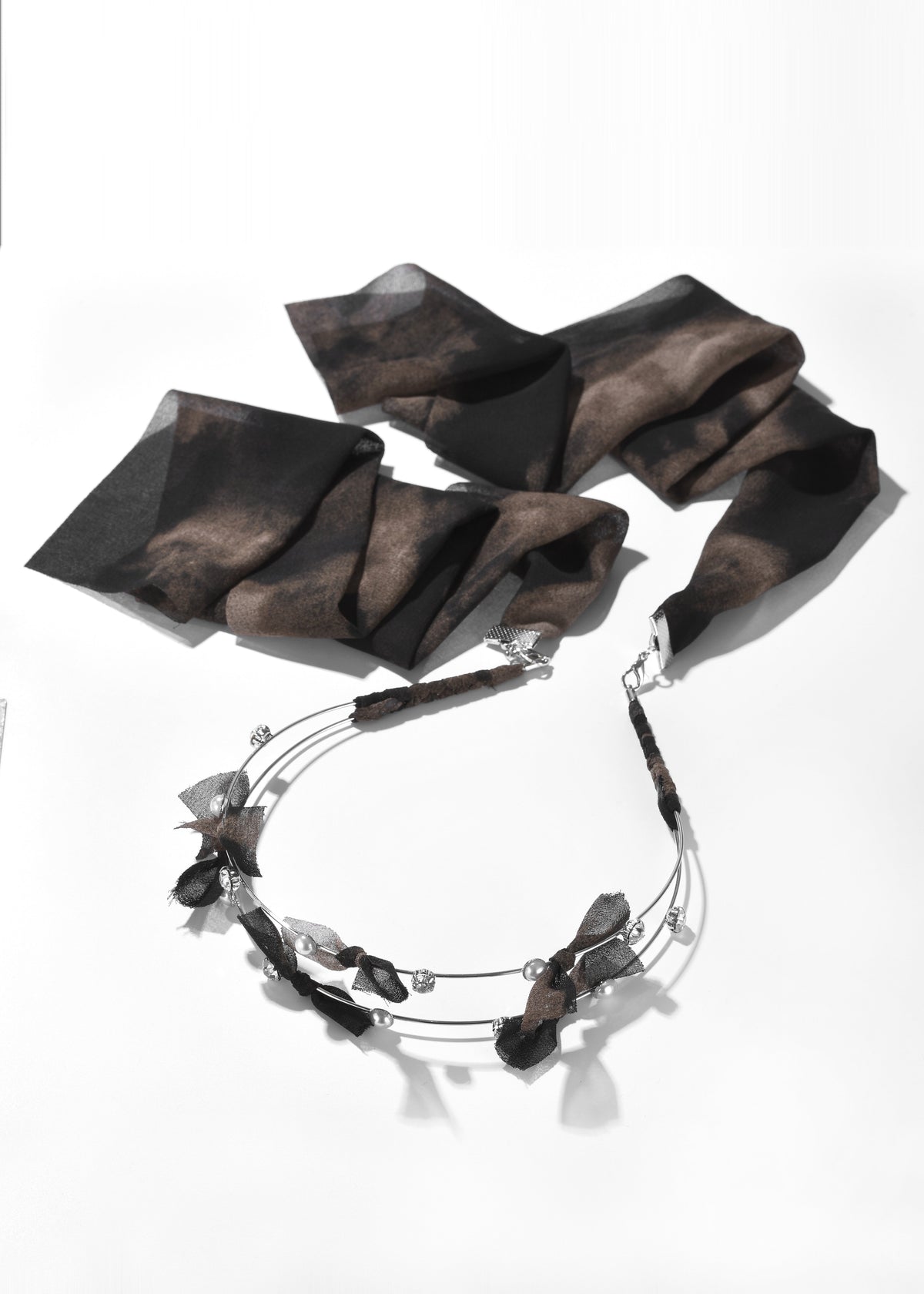 Fabric headband with a brown patterned ribbon and decorative metal band