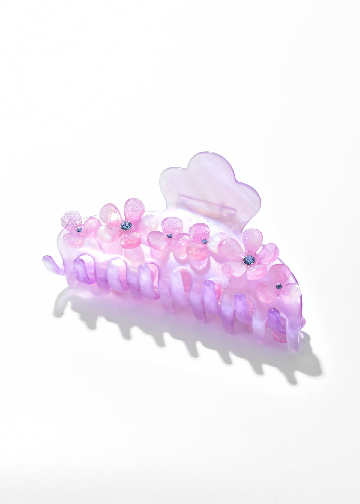 Purple hair claw decorated with pink flowers and small bead centers