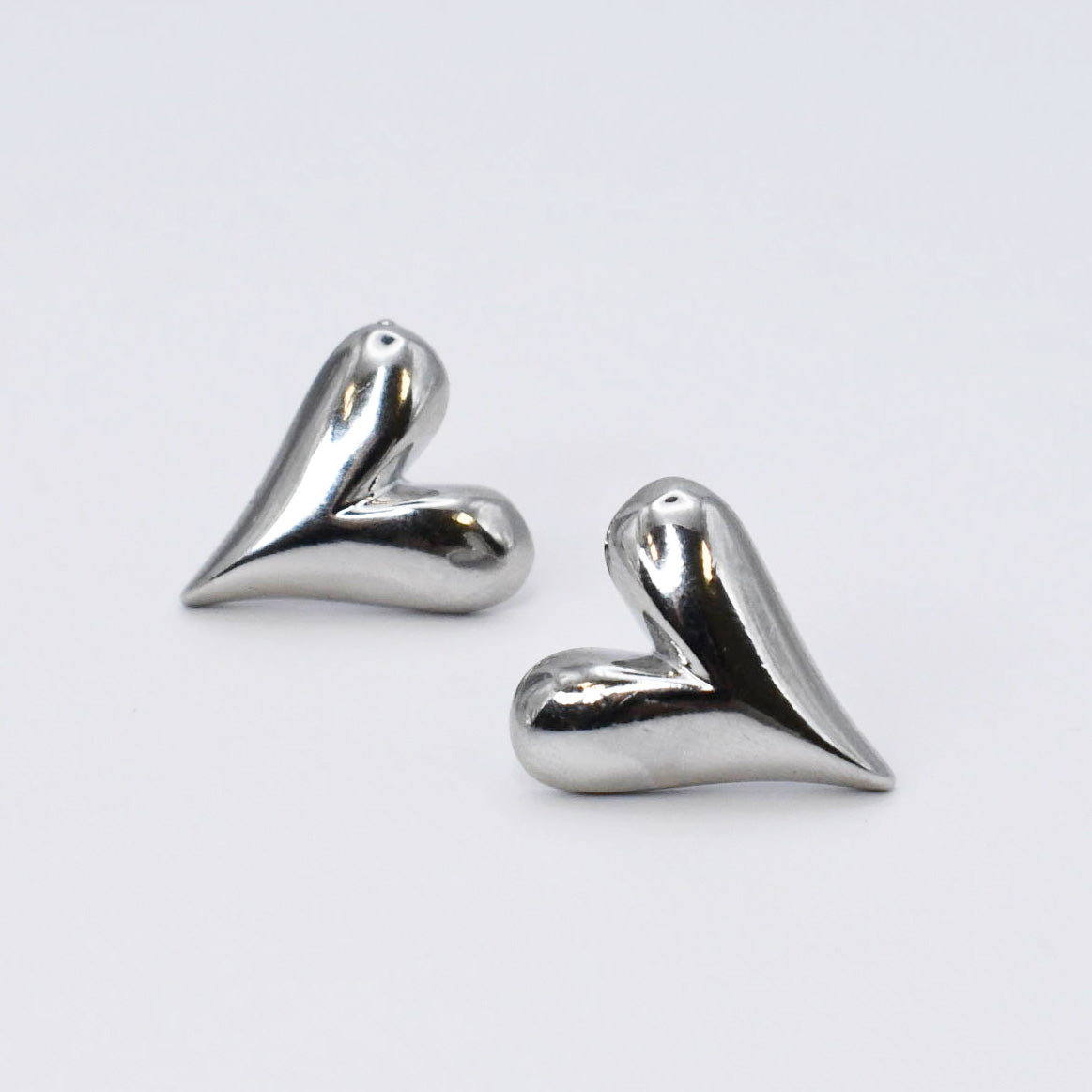 Pair of silver heart tear stud earrings with polished heart-like shape