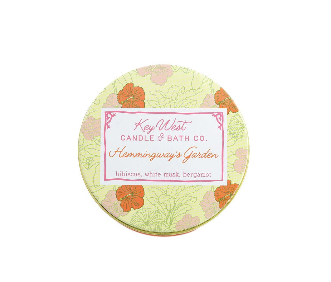 Floral garden travel candle tin with round lid label and orange flower pattern