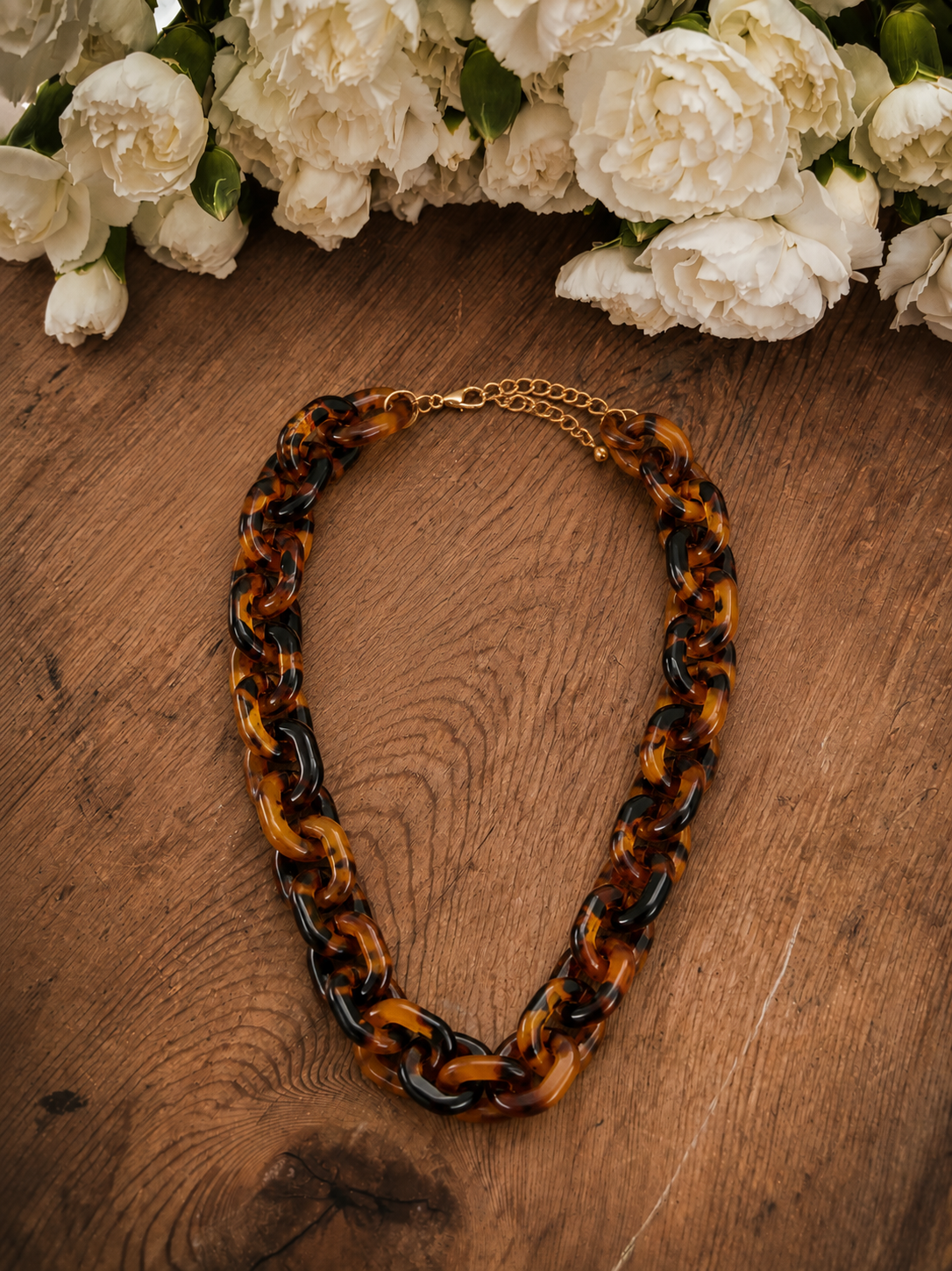 Brown acrylic link necklace with tortoiseshell-style chain, gold-tone clasp