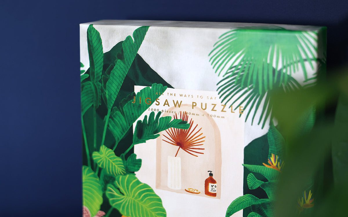 Close-up of a tropical jigsaw puzzle box with jungle bathtub artwork