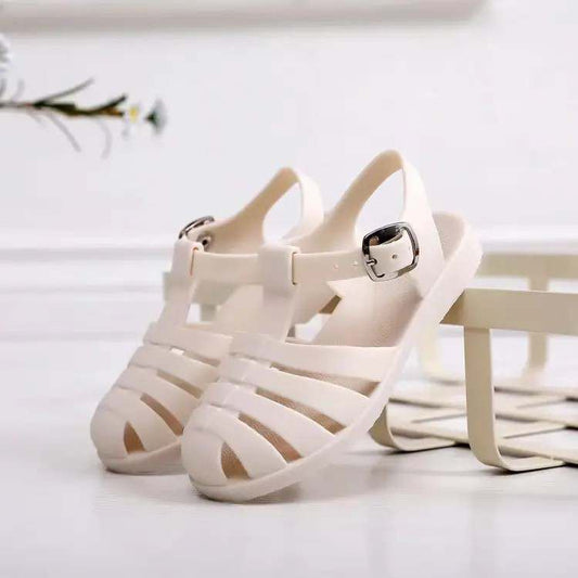 Kids' white jelly sandals with buckled ankle strap and open toe
