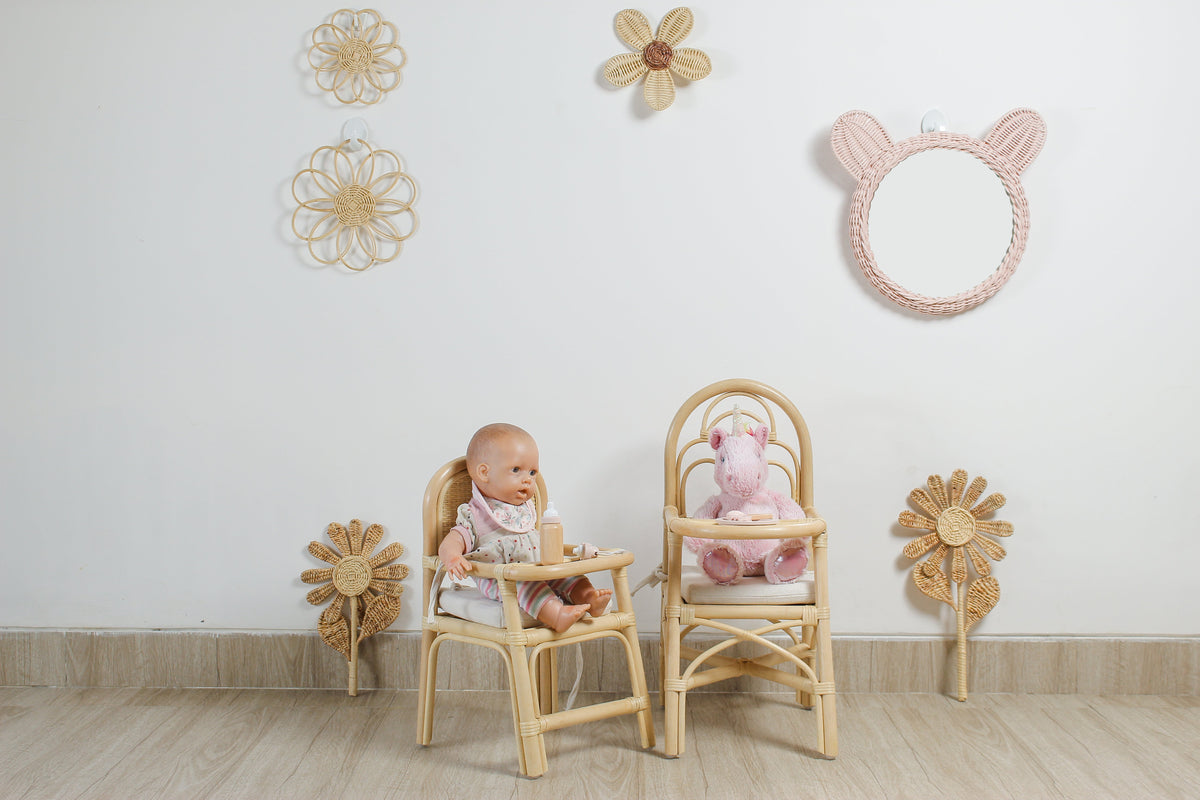 Pair of woven rattan flower stems displayed beside nursery furniture