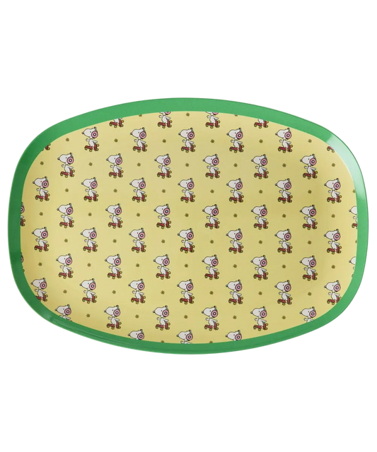 Yellow oval serving plate with green rim and repeating Snoopy pattern