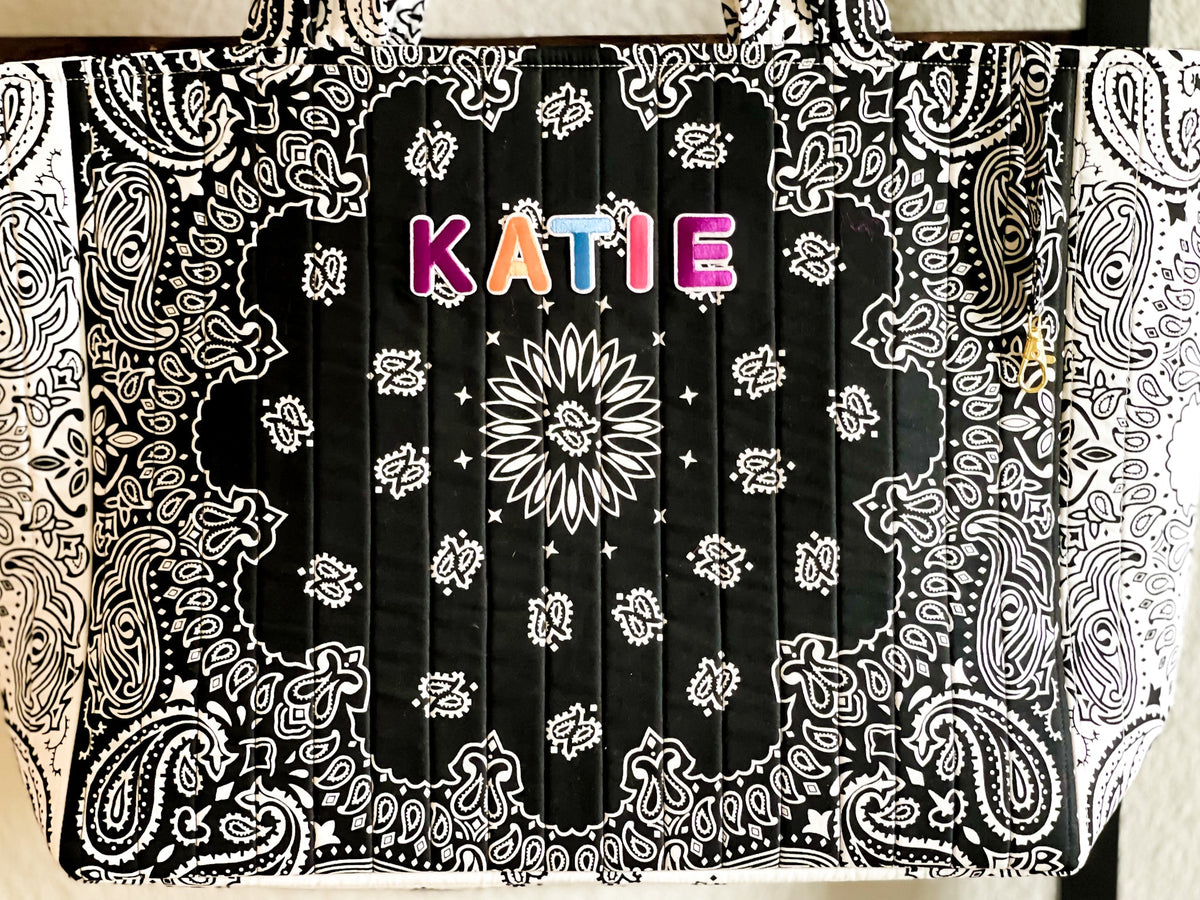 Quilted tote bag front close-up, KATIE text on black-and-white paisley