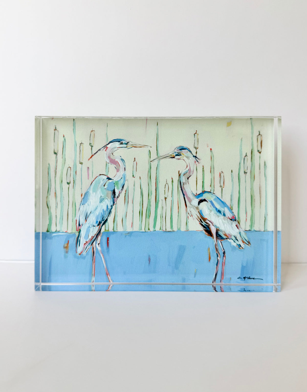 Tabletop acrylic art panel with two blue herons standing by tall reeds and blue water