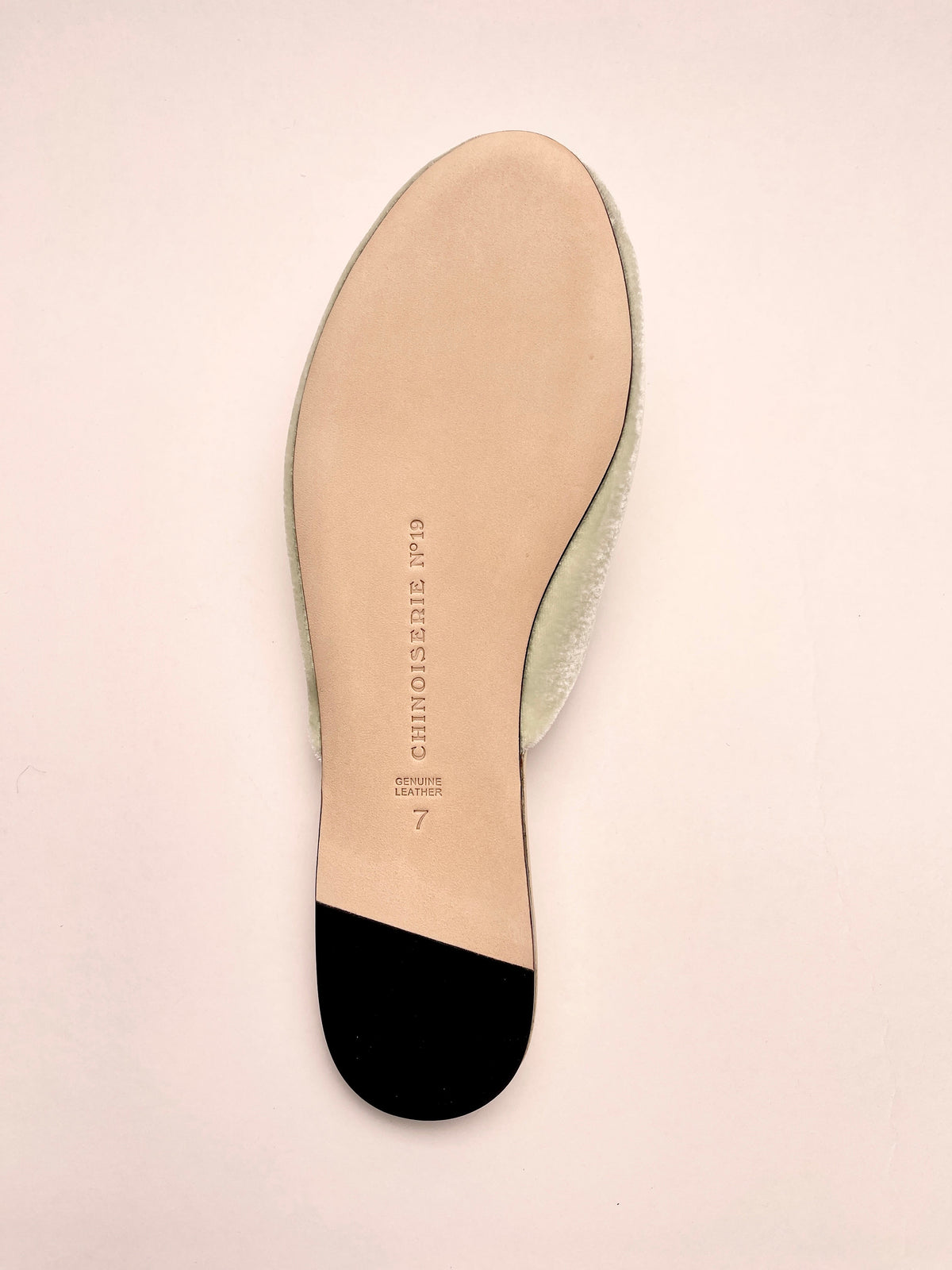 Inside footbed of mint velvet mule with printed brand text, red underside
