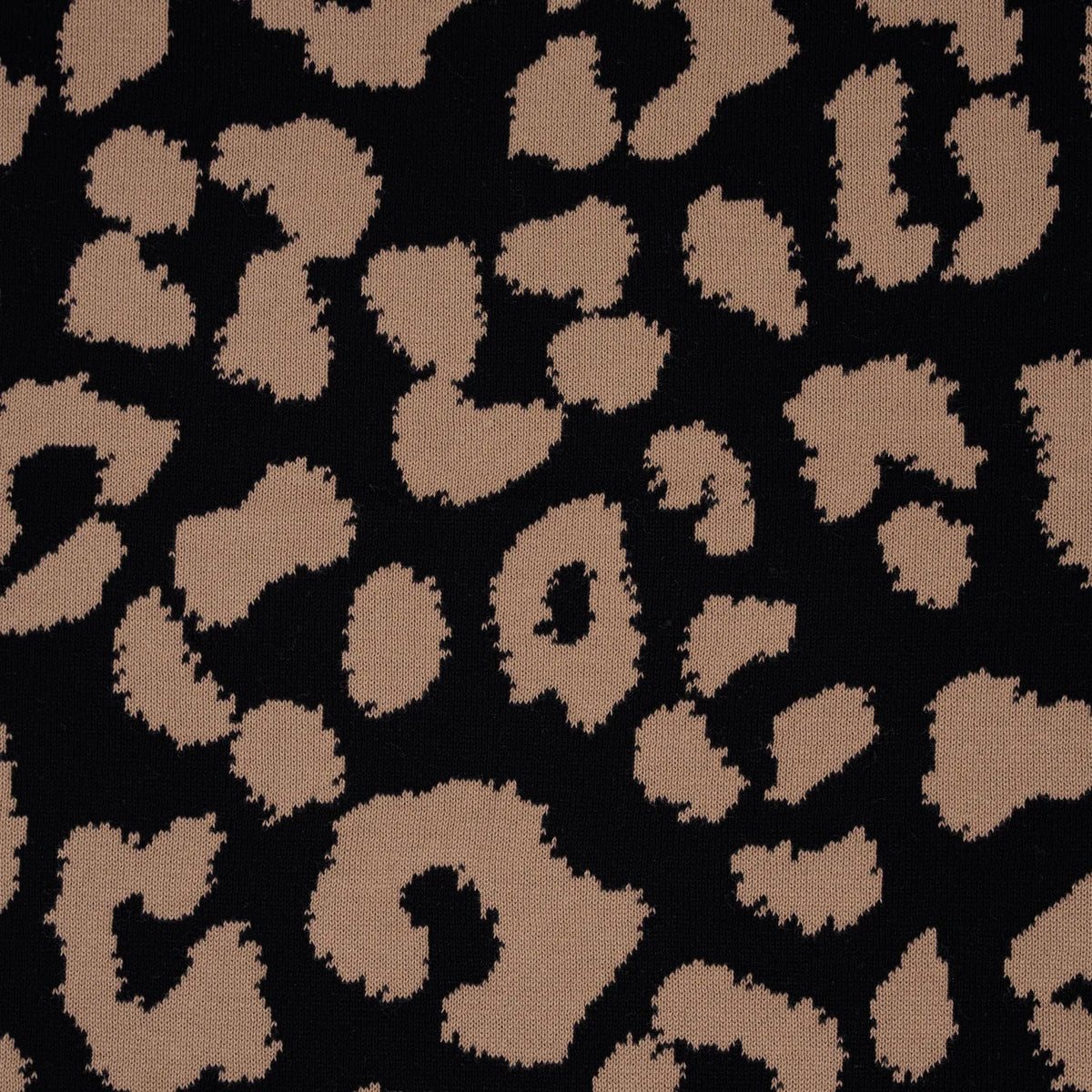 Close-up of leopard spot knit jacquard fabric in tan and dark