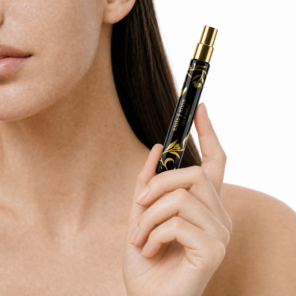 Lily & Neroli perfume bottle held near a woman's neck with black and gold design
