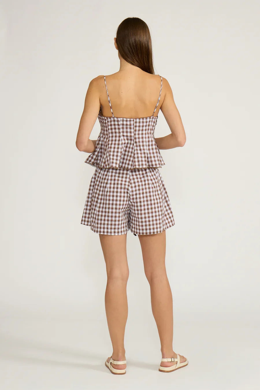 Brown gingham tank top with back spaghetti straps and peplum ruffle hem