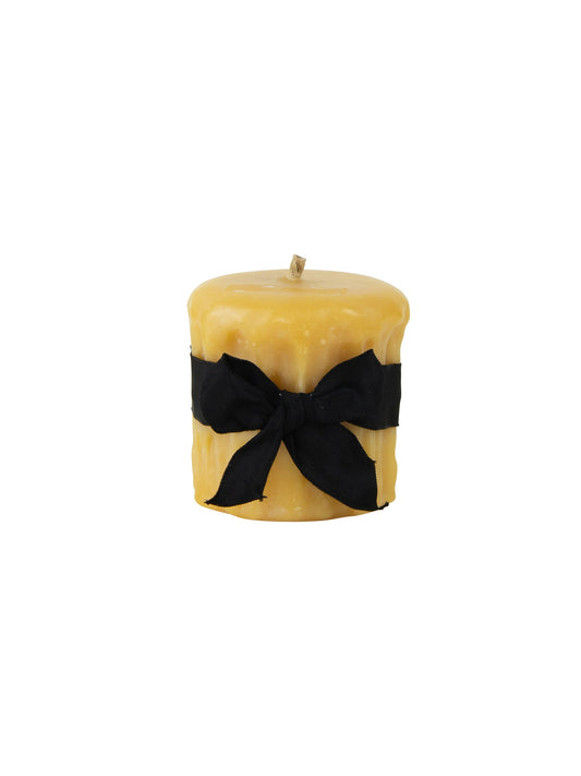 Gold beeswax drip pillar candle with black fabric bow