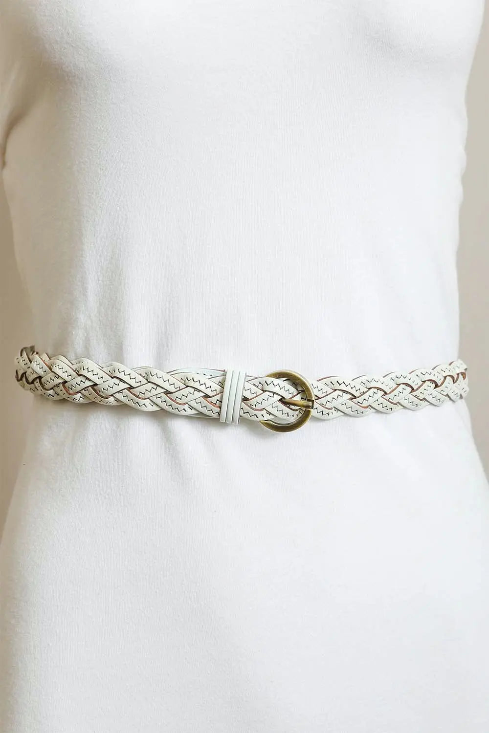 Cream braided leather belt with gold round buckle on a waist model
