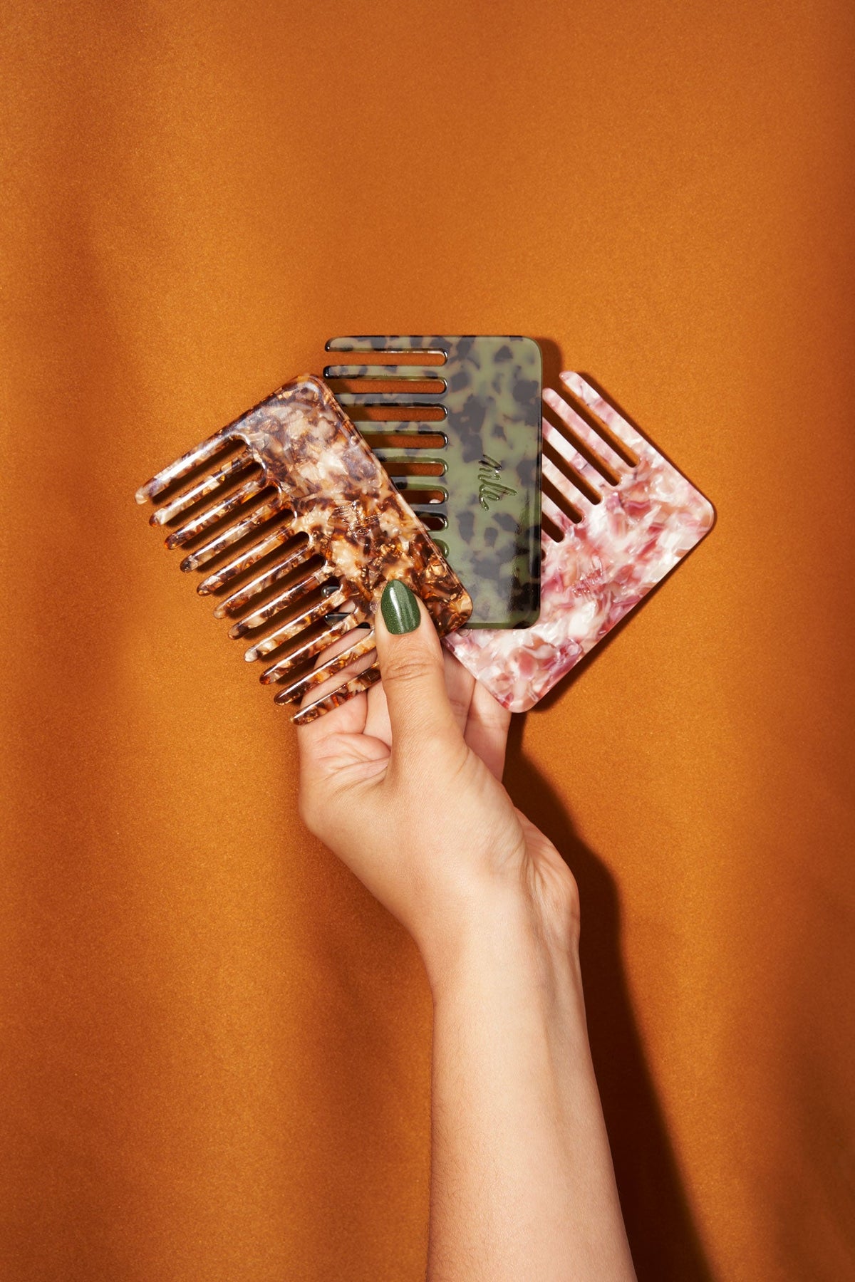 Rose and green patterned hair combs, showing two angles and teeth