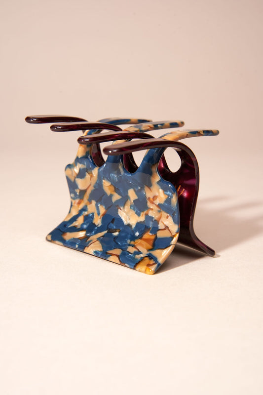 Marbled blue resin hair claw with five prongs and barrette base