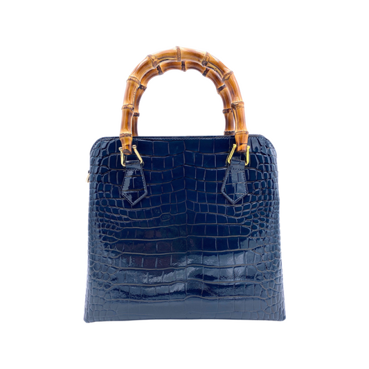 Marine blue croc-textured handbag with bamboo-style handles and central clover emblem